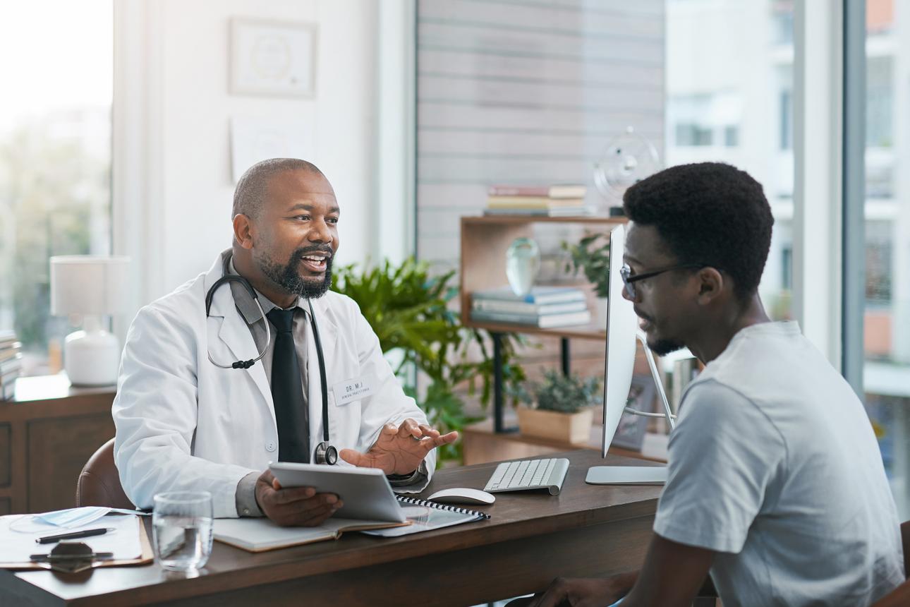 A doctor talking with a patient during a consultation