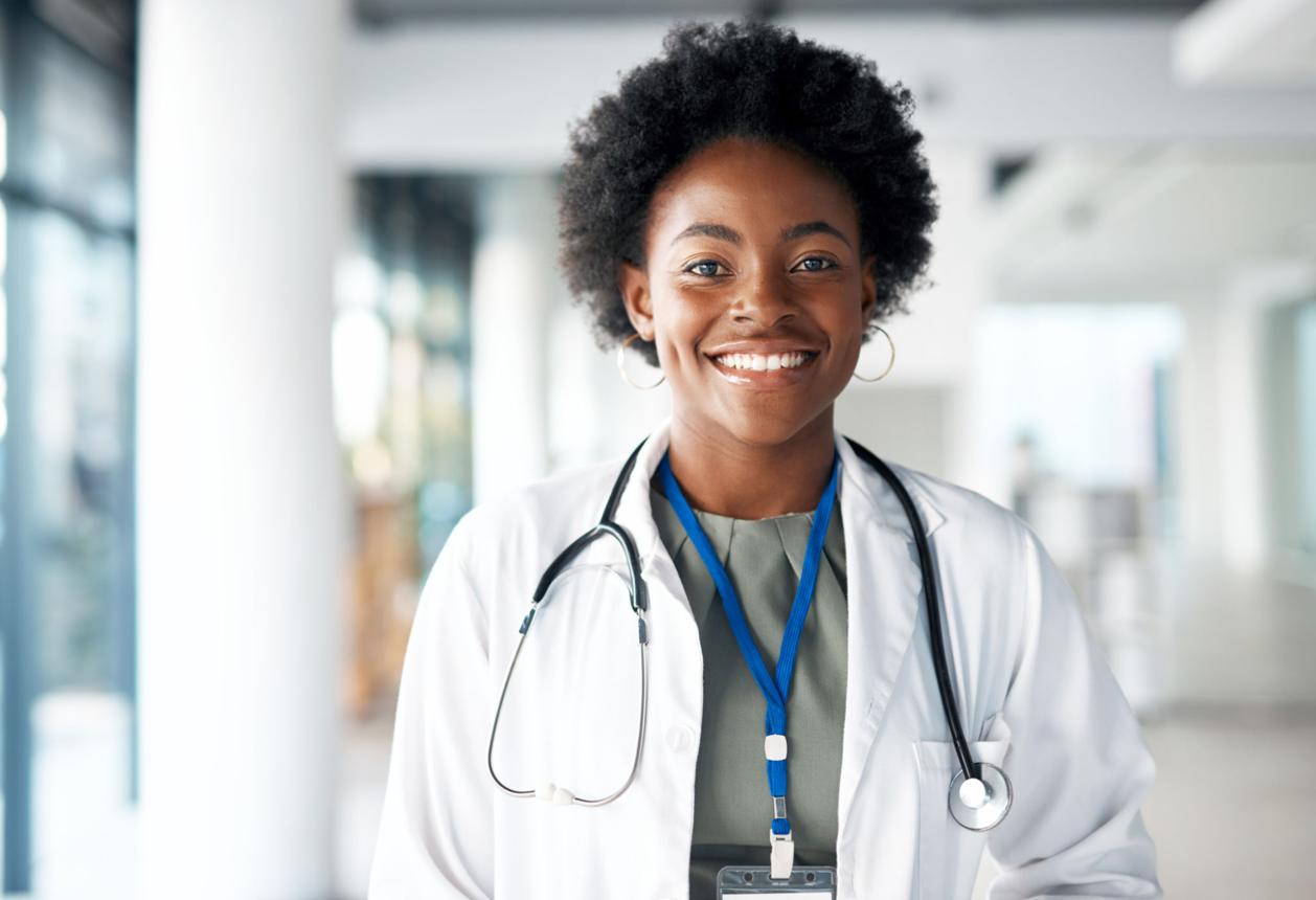 A smiling healthcare professional in a clinical setting